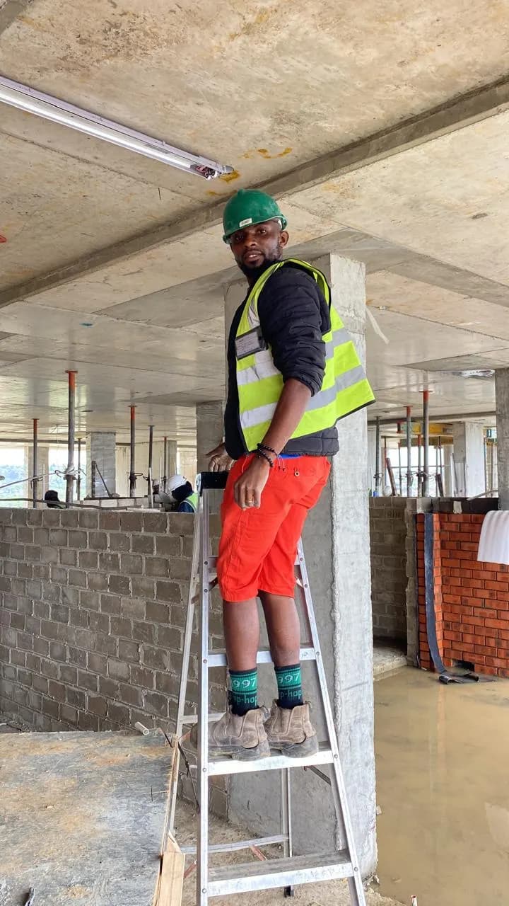 Electrician on a stepladder during first fix on a commercial floor